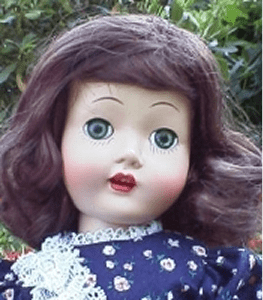 Antique doll in floral dress