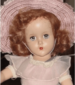 Vintage doll with pink hat and dress