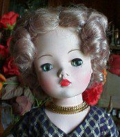 Collectible doll with red lips and necklace