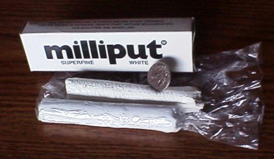 Milliput putty next to a coin